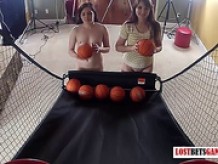 Two adorable girls play a game of strip basketball shootout